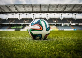 Multicolored Soccer Ball on Green Field